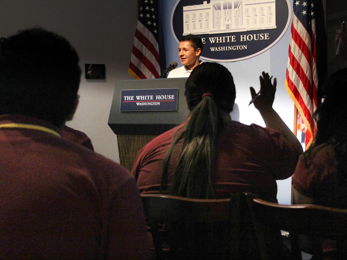 Situation Room Experience players performing a White house press conference
